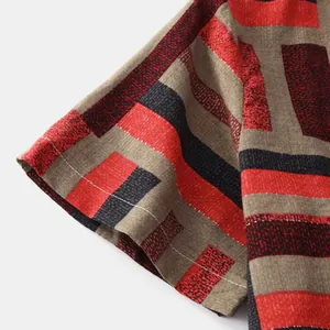 Close-up detail of men's casual shirt sleeve with red and black striped pattern