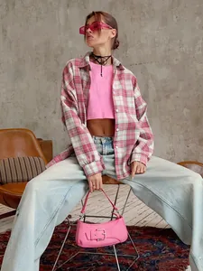 Street style model wearing a pink retro plaid long-sleeved shirt with loose fit