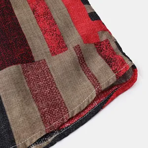 Close-up detail of color-block striped shirt sleeve with fine white stitching