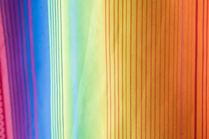 Close-up of vibrant colorful vertical striped fabric for men's Hawaiian shirt details