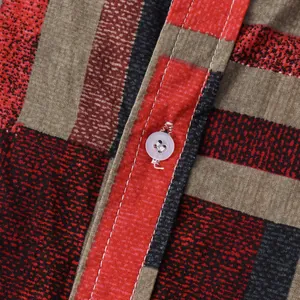 Close-up of striped men's casual shirt with white button and stitching detail