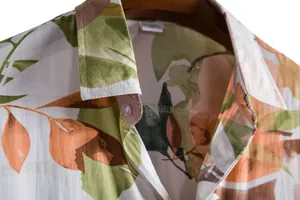 Close-up detail of tropical leaf print on a men's casual short-sleeved shirt collar