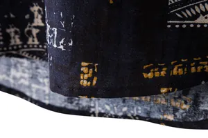 Macro view of the hem stitching and ethnic print pattern on a men's casual beach shirt