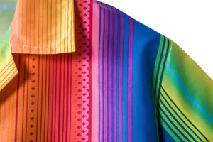 Detail of colorful ethnic print Hawaii shirt with vibrant stripes and collar view.
