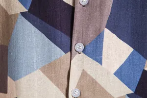 Macro detail of geometric print on men's vintage Hawaiian short sleeve button-up shirt