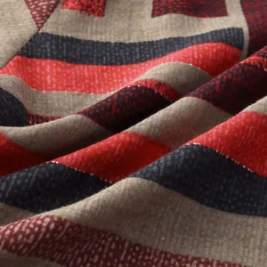Close-up showing the premium texture of woven fabric with red and black color-block stripes