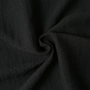 Macro detail of breathable black crinkle fabric for lightweight men's summer shirts