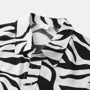 Close-up detail of a men's short-sleeved shirt with a black and white zebra pattern