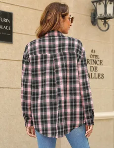 Back view of pink and black plaid shirt featuring long sleeves and curved hem detail