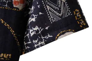 Detailed view of the vintage floral print fabric and quality stitching on a men's linen shirt
