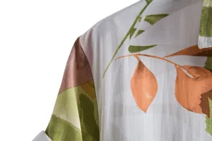 Close-up detail of lightweight floral men's casual shirt showing fabric texture and leaf print