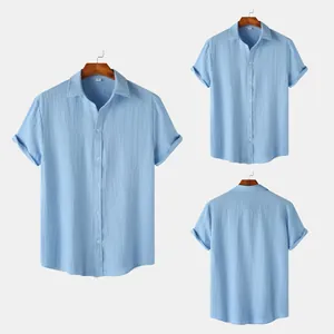 Casual men's short-sleeved shirt in light blue with textured fabric and rolled cuffs