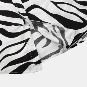Close-up macro view of the black and white zebra print and side slit on this men's shirt