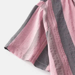 Close-up detail of summer Hawaiian men's shirt sleeve with pink and gray stripes
