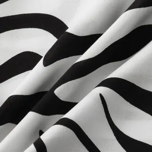 Macro close-up detail of soft black and white zebra print fabric for men's summer shirt
