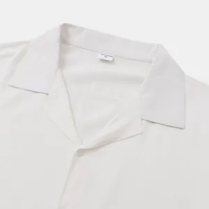 Close-up of a white men's short sleeve shirt with a camp collar and size label