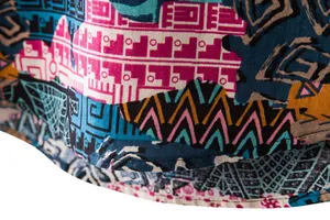 Detailed macro view of the vibrant ethnic geometric pattern on men's summer shirt