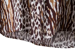 Macro detail of leopard print fabric on a men's casual short sleeve shirt