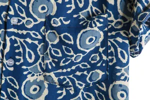 Detail view of men's Hawaiian shirt pocket with blue vintage floral print pattern