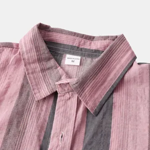 Close-up of pink and grey striped Hawaiian shirt collar with fabric texture details.