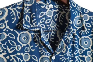 Macro detail showing the collar and blue floral print texture on men's Hawaiian shirt