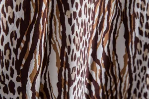 Macro view showing the detailed leopard print pattern and fabric texture of a men's shirt