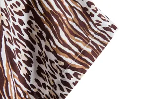 Close-up detail of the double-stitched cuff on a men's animal print casual shirt.