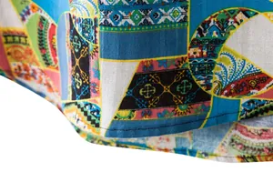 Detailed macro view of the colorful bohemian print and hem on this linen-blend men's shirt