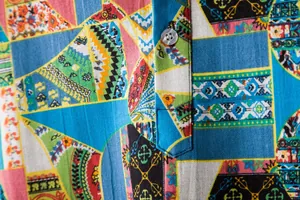 Close-up of vibrant geometric ethnic pattern on a cotton linen men's casual shirt