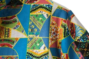 Close-up detail of a colorful geometric print cotton linen casual shirt for men.
