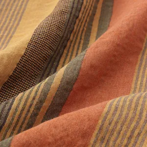 Macro detail of the breathable striped linen fabric used for a Hawaiian beach shirt