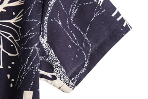 Close-up of the short sleeve and retro print on a men's Hawaiian vacation shirt