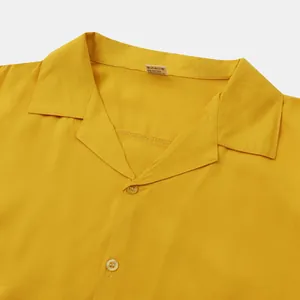 Close-up of yellow men's casual shirt collar showing soft cotton blend texture