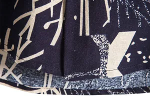 Macro view of men's vintage Hawaiian shirt fabric showing detailed print and hem