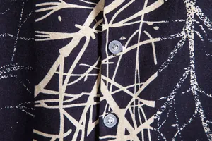 Close-up of vintage Hawaiian print short sleeve shirt with textured fabric and buttons