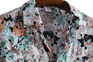 Detailed macro view of artistic abstract floral pattern on men's casual short sleeve shirt collar