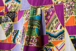Detailed close-up of a colorful geometric and floral print men's linen shirt fabric