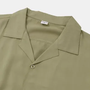 Detail view of sage green men's short sleeve casual shirt collar with size M label