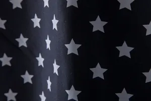 Close-up of white star pattern on navy fabric for men's Hawaiian short sleeve shirt