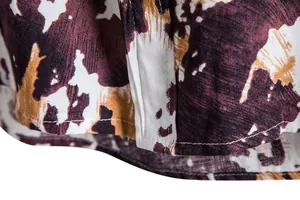 Close-up of brown floral pattern and hem stitching on men's casual short sleeve shirt