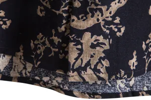 Close-up detail of vintage floral print and fabric texture on men's Hawaiian shirt