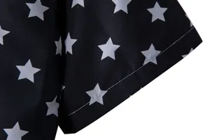 Close-up detail of white star patterns on a black men's short sleeve shirt sleeve.
