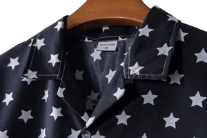 Close-up detail of a black men's Hawaiian shirt featuring a white star print pattern