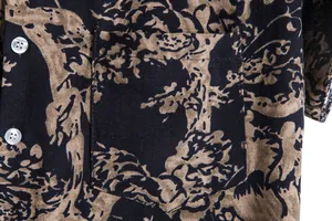 Close-up detail of vintage floral printed Hawaiian shirt showing pocket and fabric texture.