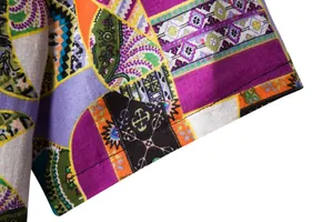 Detailed macro view of men's bohemian ethnic print linen shirt fabric and seams