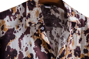 Close-up detail showing the collar and brown abstract print of this men's casual shirt