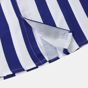 Close-up detail of blue and white striped shirt showing neat stitching and placket
