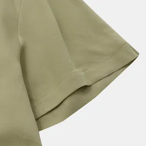 Close-up detail of olive khaki cotton twill short sleeve cuff showing neat stitching
