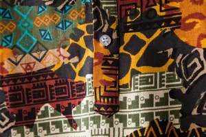 Close-up of men's short-sleeved shirt with ethnic geometric pattern and linen texture.