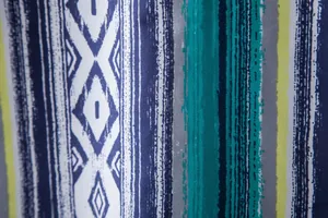 Detailed view of vibrant ethnic tribal patterns and stripes on Hawaiian shirt fabric
